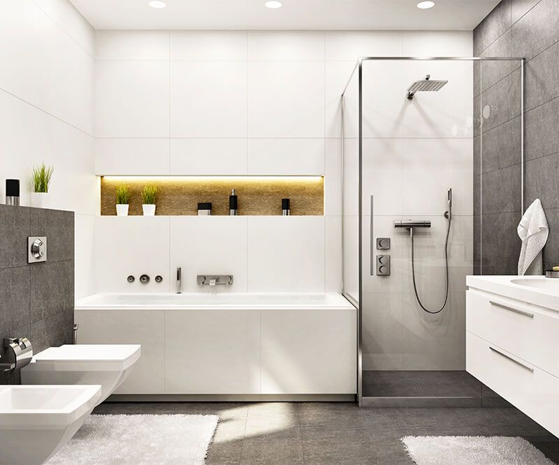 Modernes Badezimmer mit Badewanne, angrenzender begehbarer Dusche mit Glasabtrennung, Waschbecken und beleuchtetem Spiegel-Nischenregal.